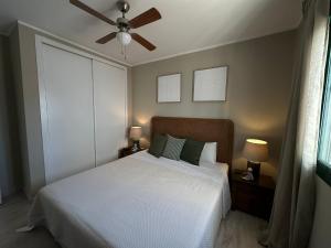 a bedroom with a white bed and a ceiling fan at Villa Casa Gran Vida in Alcaucín