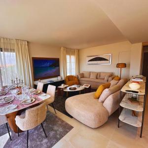 a living room with a couch and a table at VILLTAK SAINT-TROPEZ by VILLTAK Collection in Saint-Tropez