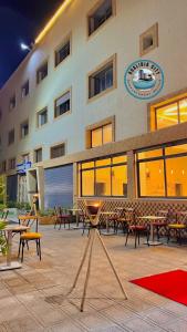 a hotel with tables and chairs in front of a building at Oualidia city in Oualidia