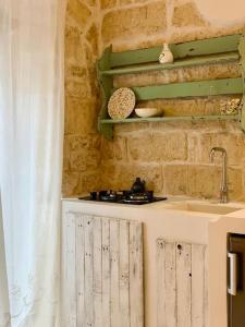 una cucina con un lavello e un piano di lavoro di Dimore i Messapi Suites Diffuse a Ceglie Messapica