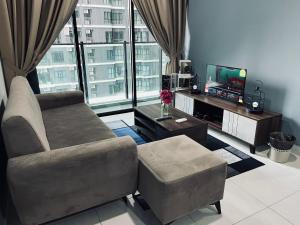 a living room with a couch and a tv at Majestic maxim 3BR luxury family house MRT kuala lumpur in Kuala Lumpur