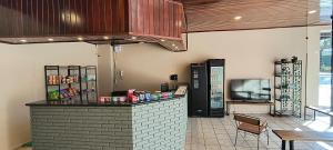 a restaurant with a counter and a tv in a room at Bravo City Hotel Sorocaba in Sorocaba