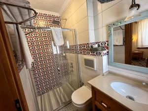 a bathroom with a shower and a toilet and a sink at Eski Datça Otel in Datca +62 photos