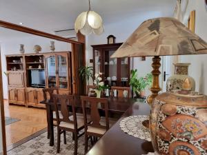 a dining room with a table with a lamp on it at Apartment Maja in Omiš