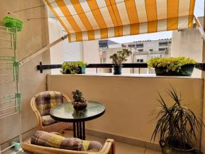 a table and chairs on a balcony with potted plants at Apartment Maja in Omiš