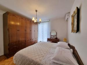 a bedroom with a bed and a chandelier at Apartment Maja in Omiš