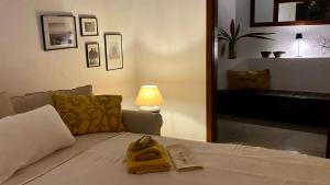 a bedroom with a bed with yellow towels on it at Casa Moni con Vistas al Mar in Playa de Santiago