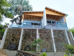a house on top of a stone wall at Kaz Samèm in Les Avirons