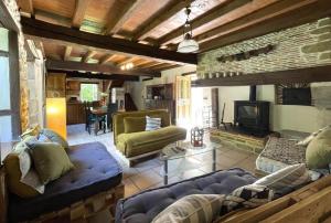 a living room with a couch and a fireplace at B&B - Chambres d'Hôtes Acoucoula in Orthez