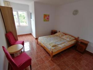 a bedroom with a bed and a table and a chair at Casa din Vamă in Vama Veche +19 photos