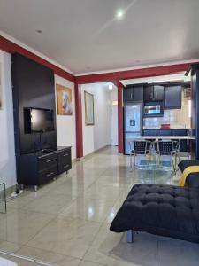 a large living room with a couch and a kitchen at Accommodation Front - Beachfront 3 Sleeper with Ocean Views in Durban