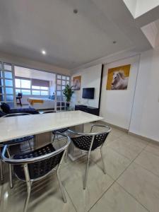 a living room with a large table and chairs at Accommodation Front - Beachfront 3 Sleeper with Ocean Views in Durban