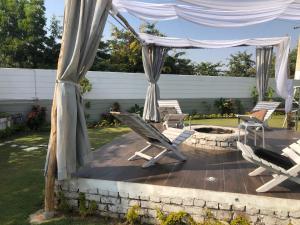 a patio with chairs and a gazebo at Lush Green Retreat Private Pool & Garden Villa, Jaipur in Jaipur
