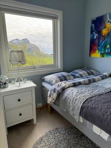 a bedroom with two beds and a window at Amazing seaview - Lodge in Bodø