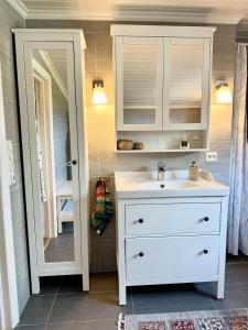 a bathroom with a white sink and a mirror at Amazing seaview - Lodge in Bodø +28 photos
