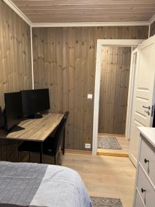 a bedroom with a desk and a bed and a door at Amazing seaview - Lodge in Bodø