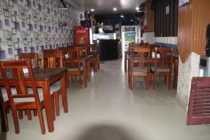 a dining room with wooden tables and chairs at Hotel Megha Heritage in Surkhet