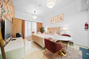 a hotel room with a bed and a table at Studio in Dubai