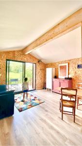 a person standing in a living room with a kitchen at Bienvenue moto vélo lanquais varennes in Varennes