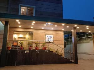 a building with a sign that reads hotel off center at Hotel Vip Square in Puri