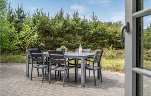 a table and chairs sitting on a patio at Holiday Home Lyngvejen Xi in Rømø Kirkeby +21 photos