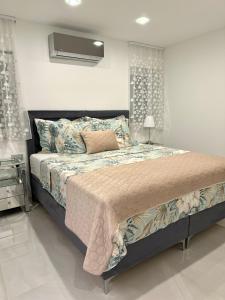 a bedroom with a large bed with a night stand at HelaMoni, New 5 Star 2 Person apartments with pool in Malinska +51 photos