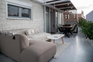 a living room with a couch and a table at NATIVO in Preveza