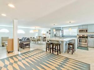 a kitchen and living room with a table and chairs at SEA SPRAY in Tybee Island
