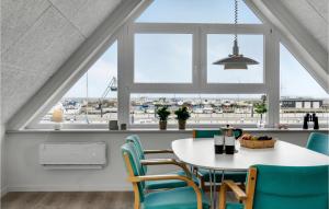 a dining room with a table and chairs and a window at Nice Apartment In Hemmet With Wifi in Hemmet