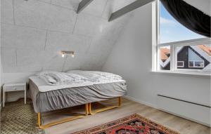 a bed in a room with a large window at Nice Apartment In Hemmet With Wifi in Hemmet +10 photos