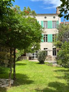 an old house with a tree in front of it at L'enthousiasme in Prades