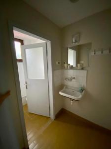 a bathroom with a white door and a sink at Yomra İkisu Garden House in Yomra