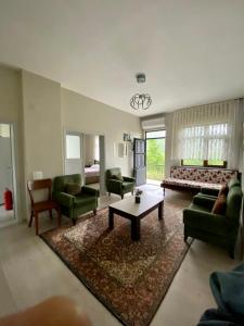 a large living room with a couch and a bed at Yomra İkisu Garden House in Yomra
