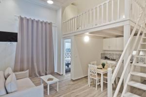 a living room with a loft bed and a kitchen at Posidonia Luxury Suites in Karpathos