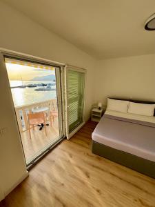 a bedroom with a bed and a view of the ocean at Villa Rozika in Baška Voda +98 photos