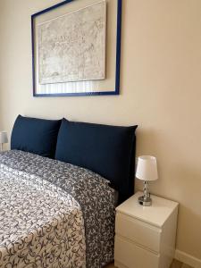 a bedroom with a bed and a picture on the wall at F&F Rooms in Pisa