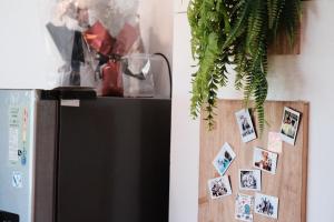 a refrigerator in a kitchen with pictures on the wall at 耶舍 yes sir 潛水旅宿1館2館 in Green Island