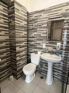 a bathroom with a toilet and a sink at Magic Hotel in Tbilisi City