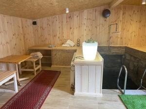 a room with wooden walls and tables and a vase on a table at Chybotek Premium Domek Danusia in Przesieka