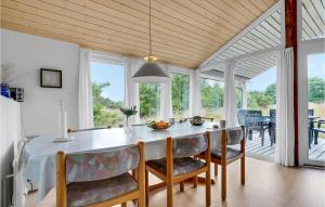 a kitchen and dining room with a table and chairs at 3 Bedroom Lovely Home In Fanø in Fanø