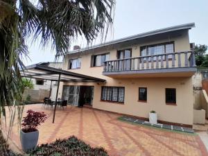a house with a balcony and a courtyard at 54 Malcolm Hidden Gem near Musgrave in Durban