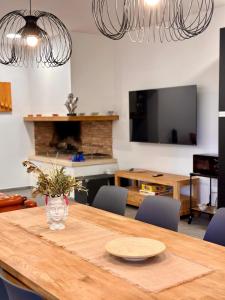 a dining room with a wooden table with chairs at La Sovrana dei Cimini in Bagnaia