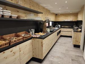 a large kitchen with a counter with food on it at Apart Ideal in Ladis
