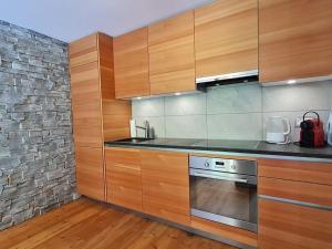 a kitchen with wooden cabinets and a stove at A Quiet Place in Siviez