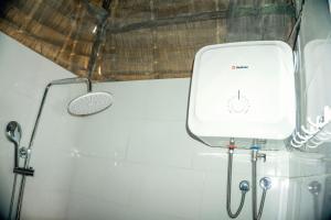 a shower in a bathroom with a sink and a shower at Moshi hostel lodge TANZANIA in Moshi +42 photos