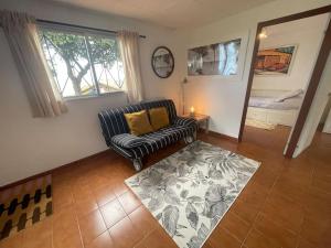 a living room with a chair and a rug at La casita del encinar in Lekeitio