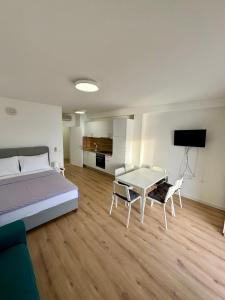 a bedroom with a bed and a table and chairs at Villa Rozika in Baška Voda