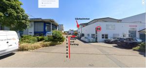 a street with a building and a car parked on the road at Haus Pleidelsheim in Pleidelsheim