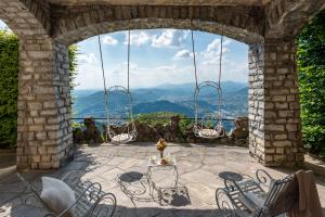 eine Terrasse mit Stühlen und einem Tisch mit Aussicht in der Unterkunft Villa Jolanda, a Garamonds Property in Brunate