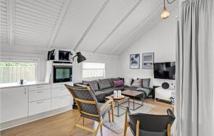 a living room with a couch and a table at Lærkereden in Vejers Strand